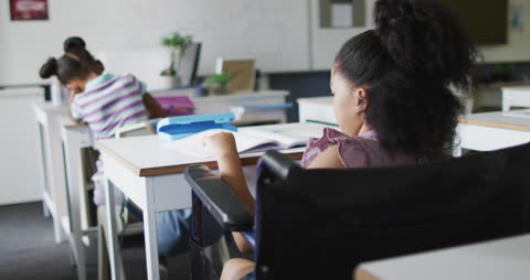 Focused Biracial Girl Studying in Classroom Environment