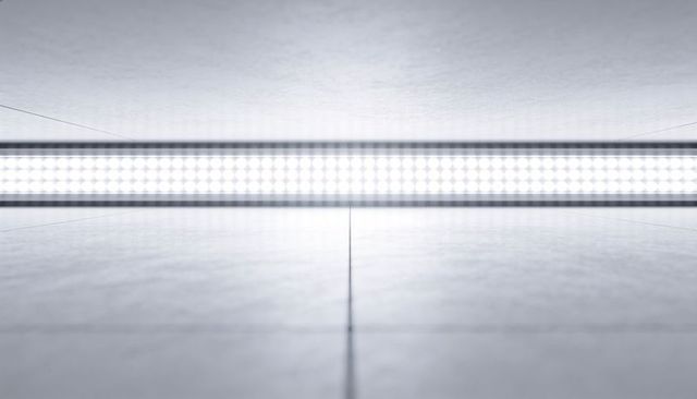 Minimal industrial interior with glowing linear led strip reflecting on tiled floor