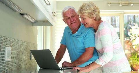 Senior Couple Using Laptop in Bright Kitchen Environment - Download Free Stock Images Pikwizard.com