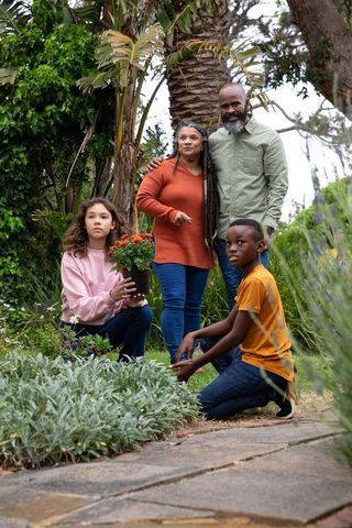 Family bonding in lush garden with vibrant blooms
