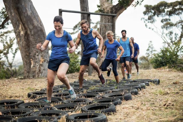 People receiving tire obstacle course training in boot camp