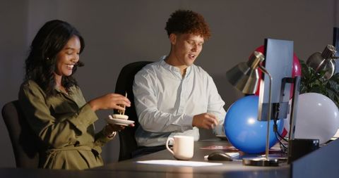 Couple Celebrating with Dessert in Relaxed Office Setting