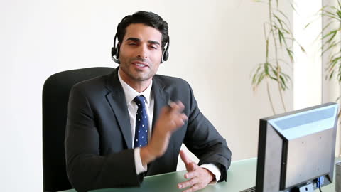 Businessman Using Headset for Customer Support at Desk