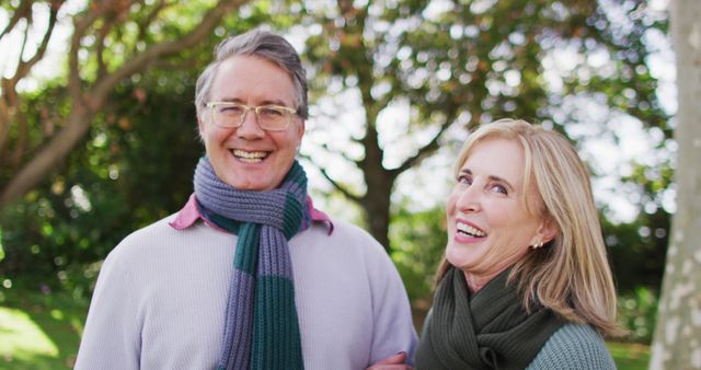 Image portrait of happy caucasian senior husband and wife talking and smiling in autumn garden. Family, domestic life and togetherness concept digitally generated image.