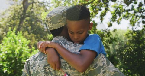 Returning African American Soldier Embracing Son in Garden - Download Free Stock Images Pikwizard.com