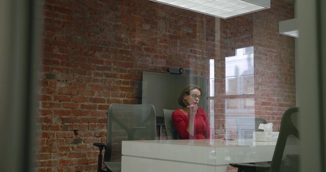 Caucasian Woman Working Diligently in Modern Office with Brick Walls - Download Free Stock Images Pikwizard.com