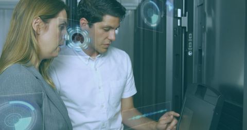 Workers analyzing digital interface in modern server room