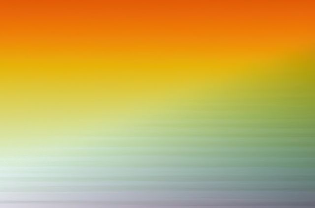 Vibrant gradient background blending warm orange, yellow, and green tones, perfect for modern design projects, digital wallpapers, presentations, and advertisements. This abstract and colorful background can add a pop of color to promotional materials, website backdrops, and social media graphics.