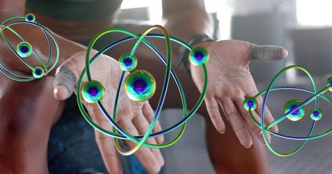 Athlete presenting augmented reality orbital orbs over chalked hands during gym training