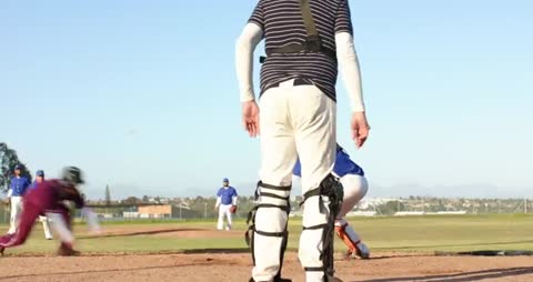 Baseball Players in Action with Runner Sliding to Base