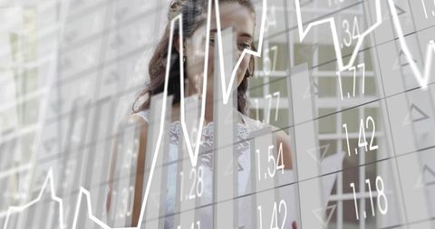 Woman analyst holding tablet viewing financial charts through glass, corporate analytics