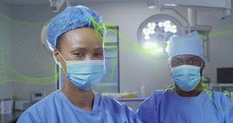 Surgeons in OR wearing blue scrubs and masks under surgical lights with digital overlay
