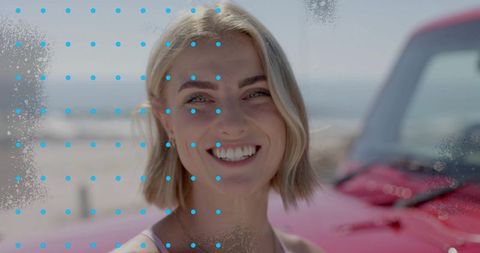 Cheerful Woman in Beach Setting Near Red Convertible