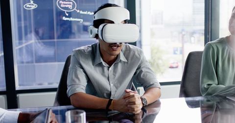 Businessman using vr headset in office meeting for innovative presentation