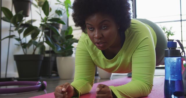 Focused African American Woman Doing Plank Exercise at Home - Download Free Stock Images Pikwizard.com