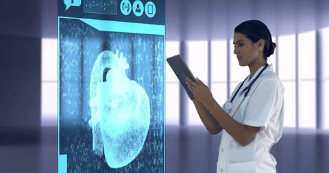 Doctor using tablet to analyze digital heart data in hospital