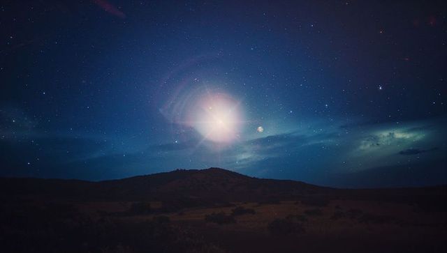 Brilliant Star Shining Above Desert Landscape at Night