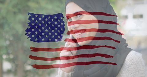 American cultural diversity represented by woman in hijab using smartphone