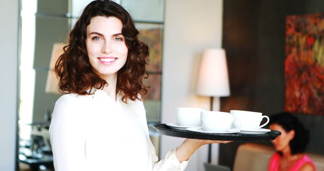 Smiling waitress serving coffee in modern cafe - Download Free Stock Images Pikwizard.com