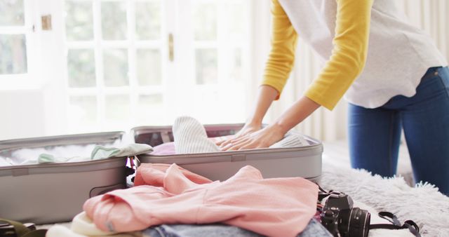 Person Packing Suitcase with Clothes and Camera - Download Free Stock Images Pikwizard.com