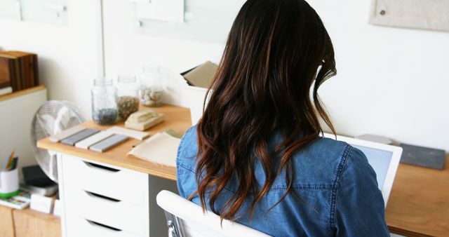 Woman using digital tablet at wooden desk in modern home office - Download Free Stock Images Pikwizard.com