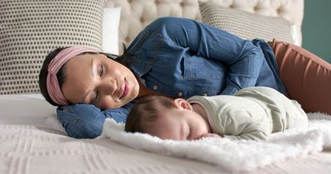 Mother and Baby Sleeping Peacefully in Cozy Bedroom Setting
