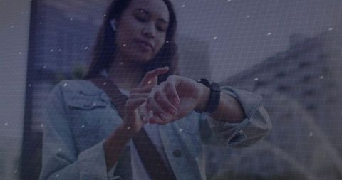 Woman interacting with smartwatch in urban environment