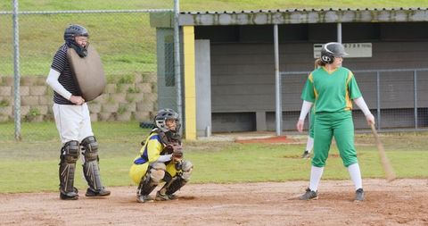 Female Batter Ready for Pitch on Baseball Field