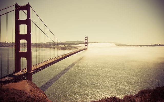 Golden Gate Bridge Bathed in Golden Sunset with Dense Fog - Download Free Stock Photos Pikwizard.com
