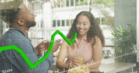 Young couple discussing investments over coffee with green stock chart in city cafe