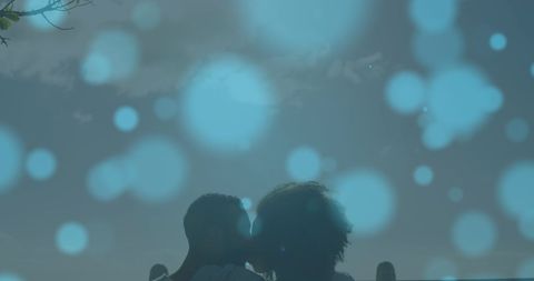 Romantic Biracial Couple Sharing Tender Kiss With Dreamy Light Bokeh