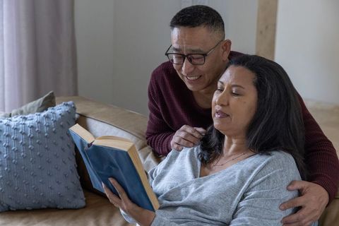 Loving Couple Enjoying Reading in Cozy Home Setting