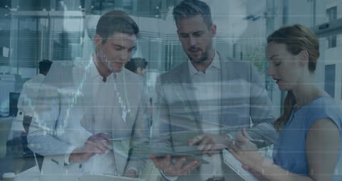 Coworkers Analyzing Financial Reports with Tablet and Market Graph Overlay