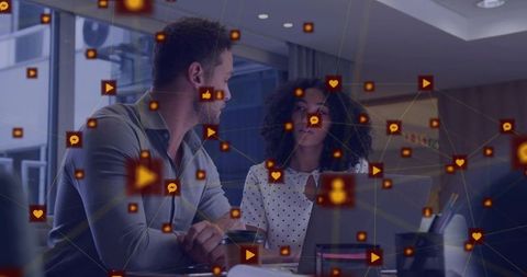 Collaborating over laptop in modern office with digital social media network overlay for teamwork