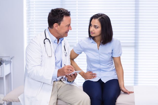 Doctor consulting a patient experiencing stomach ache in a clinic. Useful for healthcare, medical consultation, patient care, and health-related content. Ideal for illustrating doctor-patient interactions, medical advice, and healthcare services.