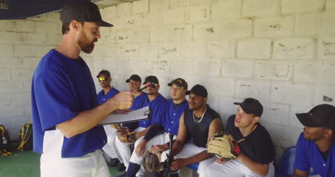 Baseball Coach Discussing Strategy with Multi-Ethnic Team