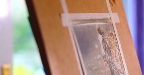 Close Up of Canvas Painting Featuring Man Riding a Horse