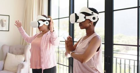 Women Practicing VR Yoga at Home — Mindful Balance and Wellness with Virtual Reality Headsets