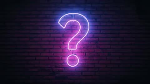 Glowing Neon Question Mark on Red Brick Wall