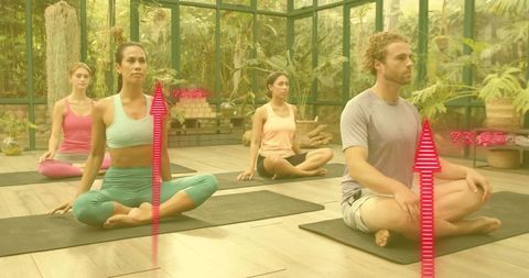 Group meditating in sunlit glass greenhouse with tropical plants and wellness hud
