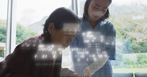 Homecare nurse guiding senior using tablet with digital overlay for healthtech wellness