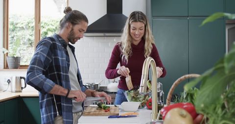 Couple Enjoys Cooking Together in Modern Kitchen