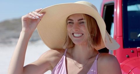 Young Woman Enjoying Sunny Beach Day in Wide-Brimmed Hat - Download Free Stock Images Pikwizard.com