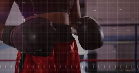 Female boxer in ring analyzing metrics