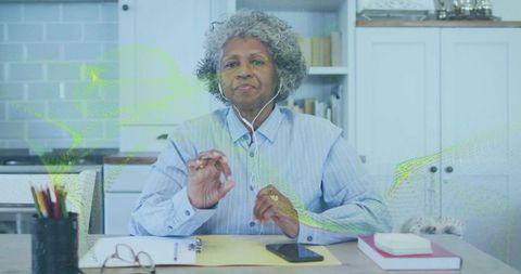 Senior Woman Engaging in Virtual Meeting at Home Desk