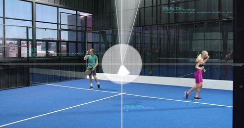 Indoor padel players using hud training overlay on blue court in urban glass arena hydration break
