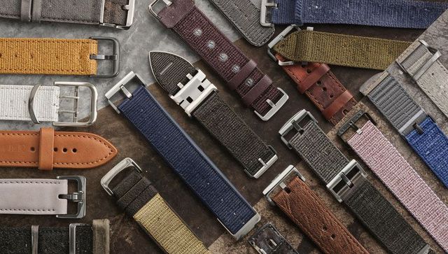 Crafted leather and canvas watch strap collection showing metal buckles and fabric textures