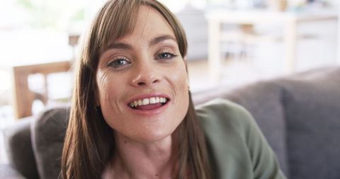 Joyful middle-aged woman smiling indoors