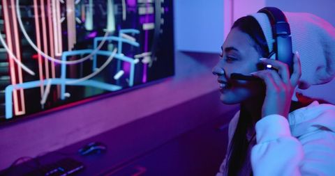 Enthusiastic gamer enjoying online gaming session with headset