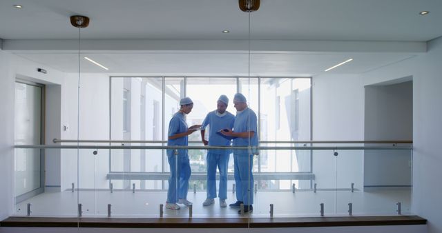 Surgeons Discussing Medical Matter in Modern Hospital Corridor - Download Free Stock Images Pikwizard.com